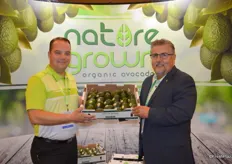 Kraig Loomis and Dan Acevedo with GreenFruit Avocados proudly show a box of organic avocados. Kraig just joined GreenFruit as the company's Sales & Marketing Manager.