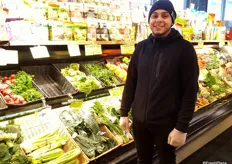 A City Acres team member is proud of the produce section.