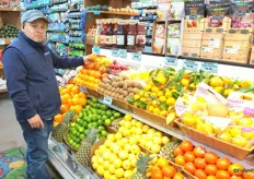 Assitant manager Alfredo Lucero next to the colorful citrus display.