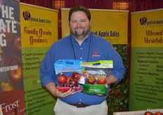 Josh Tunstall with United Apple Sales shows Ruby Frost and SnapDragon apples.