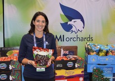 Danelle Huber with CMI Orchards proudly shows the first pick of the company’s Chelan cherries.