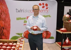 Kevin Tritz with Twin Lake Cranberry out of Wisconsin proudly shows a mesh bag with cranberries.