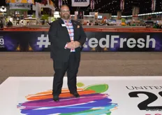 John Toner with United Fresh stands on the new logo of the United Fresh Show at the entrance of the show floor.