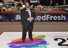 John Toner with United Fresh stands on the new logo of the United Fresh Show at the entrance of the show floor.