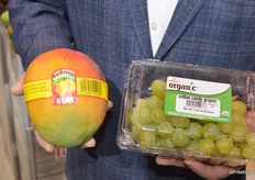 Close-up of tree ripened Kent mangos and organic cotton candy grapes from Melissa's.