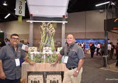 Ricardo Valencia and Dan Miller of JBM Produce, showing off their asparagus which is wrapped in seasonal tags.