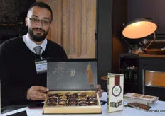 Musab Nazzal, the general manager of Pure Palestine, holding one of the company's premium packaging options: a selection of stuffed dates.