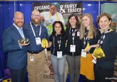 The ladies of Equal Exchange proudly smile for a picture with two gentlemen of Four Seasons Produce, who buy avocados and bananas from them. 