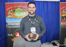 Chad Hackenbracht with Tastee Apples shows one of the company's bestsellers: an apples dipped caramel, dipped in dark chocolate, rolled in pecans and drizzled with milk chocolate.