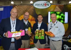 The team of Amazon Produce Network proudly show a selection of tropical items they brought to the show: Honey mangos, a Tianung papaya from Guatemala and a box of organic Kent mangos from Ecuador. From left to right are Greg Golden, Javier Leon, Matt Matalucci and Clark Golden.