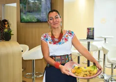Paulina Carrera wearing traditional Ecuadorian clothing while showing off Ecuador’s most important fruits.