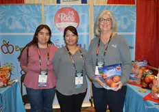 Vanessa Tacuba, Alma Tacuba and Brenda Briggs with Rice Fruit Company. Brenda shows a pouch bag of Kiku apples. 
