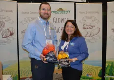 Andy Webb and Christine Toy with Progressive Produce show organic grapefruit and organic lemons in mesh bags.