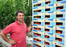 Salvatore Asta next to a pallet of tomatoes labelled 'Orto Kamarina'.