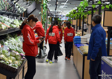 Staff at Hema, Shanghai, are collecting order for online clients. After placing an order online, each clients within a certain area around a Hema store should receive the purchase within 30 minutes, delivered at their door.