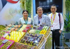 The stand of the Thai Department of International Trade Promotion. In the middle is Phatom Taenkam, English speaking advisor to the Department. In the front are different Thai subtroptical products, including dragonfruit, mango, mangosteen and longan.