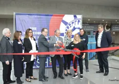 Commissioner of New York State Department of Agriculture Richard Ball and Debbie Prevor cut the ribbon, signifying the official opening of the trade show floor of the New York Produce Show. 