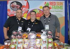 Tom Coufal, Ray Mason, and Harold Paivarinta with Red Sun Farms proudly stand behind a large display of greenhouse grown tomato, bell pepper, and cucumber offerings.