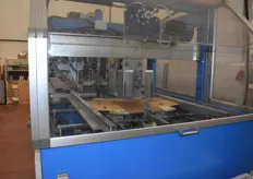 A new carton is being 'folded' open by the machine.