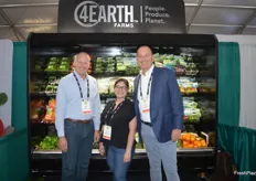 Mark Munger, Sandra Medina and Dave Hewitt stand in front of the 4Earth Farms cooler.