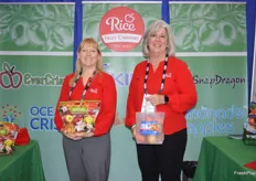 Jill Hughey and Brenda Briggs with Rice Fruit show a pouch bag of Ambrosia and Kiku apples. 