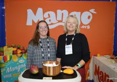 Meg Buchsbaum and Tammy Wiard with the National Mango Board. The backdrop shows the organization's new logo after a re-brand. 