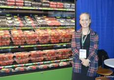 In front of a cooler with a wide selection of berries is Maggie Stubbs with Driscoll's. 