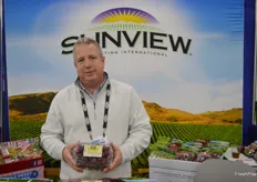 Bryan Roberts with Sunview shows Organic Red Seedless grapes from California. 