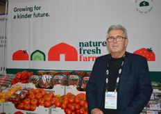 Ray Wowryk with Nature Fresh Farms in front of the backdrop that shows the company's new logo and re-brand. 